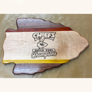 wooden arrowhead shaped board with red yellow and white highlights and kansas city chiefs super bowl champions logo