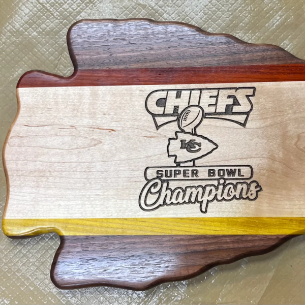 wooden arrowhead shaped board with red yellow and white highlights and kansas city chiefs super bowl champions logo