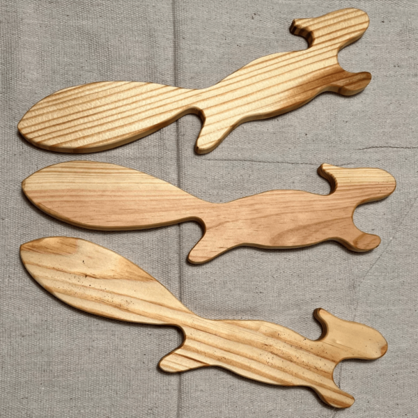 set of three wooded pieces shaped in the outline of a squirrel