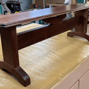 solid dark wood bench on display in a workshop