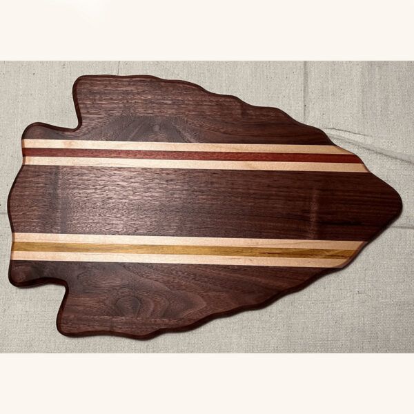 solid walnut arrowhead shaped board with red, white and yellow stripes