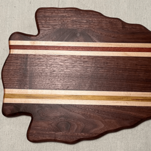 solid walnut arrowhead shaped board with red, white and yellow stripes